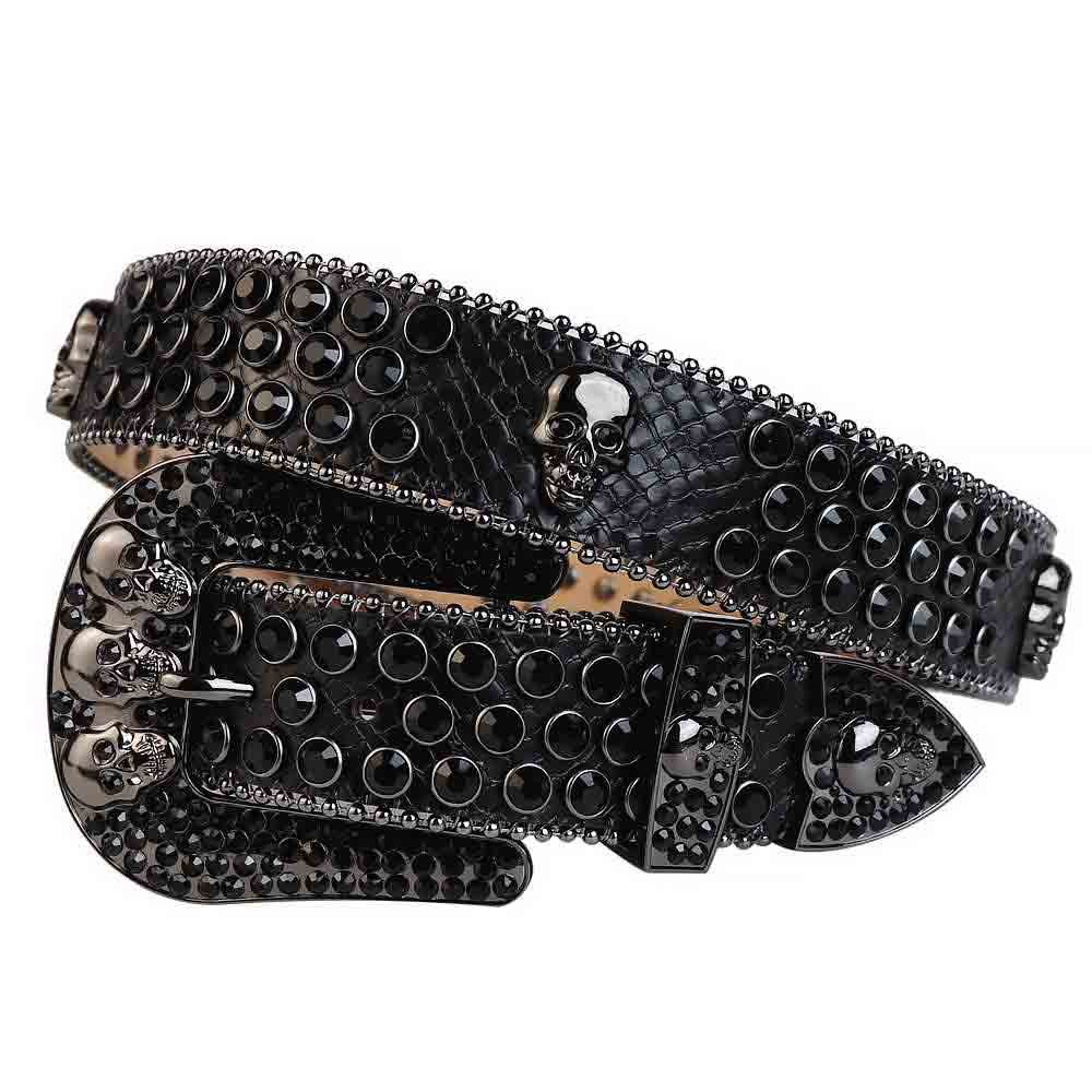 Unisex Black Leather Belt with Skulls Studded All Black Real Rhinestones & Classic Black Skull Buckle Add a touch of luxury and sparkle to your outfit with the Unisex Black Shimmer Leather Belt from Real Rhinestone. Featuring a sleek Black leather strap, this stylish belt is adorned with Black Color diamond rhinestones, creating a bold and glamorous look. The Black buckle, decorated with Black crystal rhinestones, enhances the design with extra shine and sophistication. Designed for versatility and comfort, this belt is perfect for both casual and dressy occasions. Whether you're looking to complete a hip-hop-inspired outfit, make a statement at an event, or simply add some extra bling to your wardrobe, this belt is the perfect accessory. Its adjustable fit ensures all-day comfort, while the high-quality materials guarantee durability and long-lasting wear. Elevate your style effortlessly with the Unisex Black Shimmer Leather Belt. Whether you're hitting the stage, going out with friends, or just upgrading your everyday look, this belt is a must-have. Order now from Real Rhinestone and bring some diamond-studded brilliance to your collection. Material: Premium Leather Rhinestone: Luxury Hand-Set High-Gloss Crystal Diamond Embellishments Buckle Type: Classic Horseshoe Zinc Buckle Set Featuring Engraved Design & Sparkling Rhinestones Width: 4cm (1.5 Inch) Style: Streetwear, Cowboy, Western, Partywear, Festivals & Performances, Fashion, Hip Hop, Bling, Diamond Belt Measurement: Please note that measurements may vary by 1-2 cm. Our belts are measured from the fold where the buckle is attached to the middle hole. For the best fit, we recommend measuring a belt you already own from the fold to the hole you use most frequently. Ideally, the belt should be worn on the third hole for optimal fit and comfort.