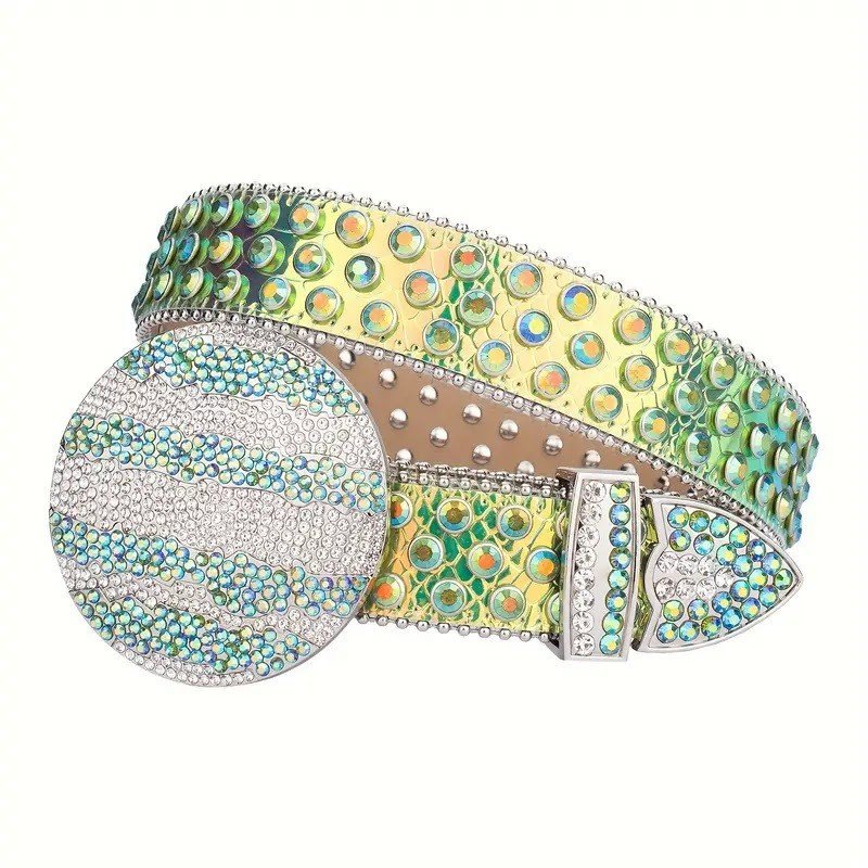 Unisex Green and Gold Iridescent Globe Leather Belt with Studded Green Iridescent Rhinestones & Silver Globe Buckle Add a touch of luxury and sparkle to your outfit with the Unisex Green Iridescent Leather Belt from Real Rhinestone. Featuring a sleek Gold and green leather strap, this stylish belt is adorned with Green Iridescent rhinestones, creating a bold and glamorous look. The Silver buckle, decorated with White and Green color crystal rhinestones, enhances the design with extra shine and sophistication. Designed for versatility and comfort, this belt is perfect for both casual and dressy occasions. Whether you are looking to complete a hip-hop-inspired outfit, make a statement at an event, or simply add some extra bling to your wardrobe, this belt is the perfect accessory. Its adjustable fit ensures all-day comfort, while the high-quality materials guarantee durability and long-lasting wear. Elevate your style effortlessly with the Unisex Green Iridescent Leather Belt. Whether you are hitting the stage, going out with friends, or just upgrading your everyday look, this belt is a must-have. Order now from Real Rhinestone and bring some diamond-studded brilliance to your collection. Material: Premium Leather Rhinestone: Luxury Hand-Set High-Gloss Crystal Diamond Embellishments Buckle Type: Classic Globe Zinc Buckle Set Featuring Engraved Design & Sparkling Rhinestones Width: 4cm (1.5 Inch) Style: Streetwear, Cowboy, Western, Partywear, Festivals & Performances, Fashion, Hip Hop, Bling, Diamond Belt Measurement: Please note that measurements may vary by 1-2 cm. Our belts are measured from the fold where the buckle is attached to the middle hole. For the best fit, we recommend measuring a belt you already own from the fold to the hole you use most frequently. Ideally, the belt should be worn on the third hole for optimal fit and comfort.