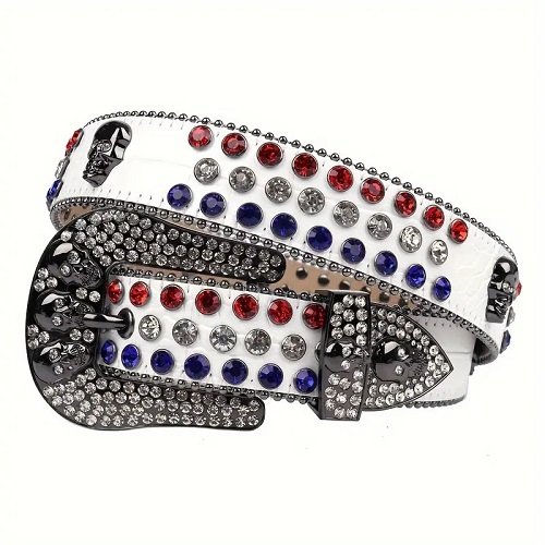 Unisex White Leather Belt with Skulls Studded All Red, Blue and White Real Rhinestones & Classic Gray Skull Buckle Add a touch of luxury and sparkle to your outfit with the Unisex White Leather Belt from Real Rhinestone. Featuring a sleek White leather strap, this stylish belt is adorned with Red, Blue and White Color diamond rhinestones, creating a bold and glamorous look. The Gray buckle, white crystal rhinestones, enhances the design with extra shine and sophistication. Designed for versatility and comfort, this belt is perfect for both casual and dressy occasions. Whether you are looking to complete a hip-hop-inspired outfit, make a statement at an event, or simply add some extra bling to your wardrobe, this belt is the perfect accessory. Its adjustable fit ensures all-day comfort, while the high-quality materials guarantee durability and long-lasting wear. Elevate your style effortlessly with the Unisex White Leather Belt. Whether you are hitting the stage, going out with friends, or just upgrading your everyday look, this belt is a must-have. Order now from Real Rhinestone and bring some diamond-studded brilliance to your collection. Material: Premium Leather Rhinestone: Luxury Hand-Set High-Gloss Crystal Diamond Embellishments Buckle Type: Classic Horseshoe And Skull Zinc Buckle Set Featuring Engraved Design & Sparkling Rhinestones Width: 4cm (1.5 Inch) Style: Streetwear, Cowboy, Western, Partywear, Festivals & Performances, Fashion, Hip Hop, Bling, Diamond Belt Measurement: Please note that measurements may vary by 1-2 cm. Our belts are measured from the fold where the buckle is attached to the middle hole. For the best fit, we recommend measuring a belt you already own from the fold to the hole you use most frequently. Ideally, the belt should be worn on the third hole for optimal fit and comfort.