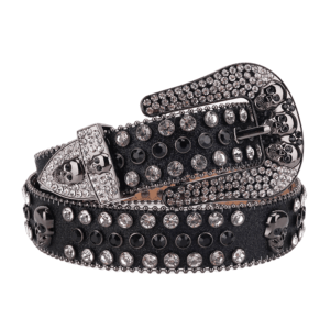 Unisex Black Leather Belt with Skulls Studded Black and Silver Real Rhinestones & Classic Gray Skull Buckle Add a touch of luxury and sparkle to your outfit with the Unisex Black Leather Belt from Real Rhinestone. Featuring a sleek Black leather strap, this stylish belt is adorned with Black and silver Color diamond rhinestones, creating a bold and glamorous look. The Gray buckle, decorated with Black and silver crystal rhinestones, enhances the design with extra shine and sophistication. Designed for versatility and comfort, this belt is perfect for both casual and dressy occasions. Whether you are looking to complete a hip-hop-inspired outfit, make a statement at an event, or simply add some extra bling to your wardrobe, this belt is the perfect accessory. Its adjustable fit ensures all-day comfort, while the high-quality materials guarantee durability and long-lasting wear. Elevate your style effortlessly with the Unisex Black Leather Belt. Whether you are hitting the stage, going out with friends, or just upgrading your everyday look, this belt is a must-have. Order now from Real Rhinestone and bring some diamond-studded brilliance to your collection. Material: Premium Leather Rhinestone: Luxury Hand-Set High-Gloss Crystal Diamond Embellishments Buckle Type: Classic Horseshoe and skull Zinc Buckle Set Featuring Engraved Design & Sparkling Rhinestones Width: 4cm (1.5 Inch) Style: Streetwear, Cowboy, Western, Partywear, Festivals & Performances, Fashion, Hip Hop, Bling, Diamond Belt Measurement: Please note that measurements may vary by 1-2 cm. Our belts are measured from the fold where the buckle is attached to the middle hole. For the best fit, we recommend measuring a belt you already own from the fold to the hole you use most frequently. Ideally, the belt should be worn on the third hole for optimal fit and comfort.