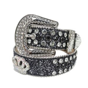 Unisex timeless Black Glitter leather belt, with studded Crown Emblem and White Rhinestones in a distinctive horseshoe pattern. Add a touch of luxury and sparkle to your outfit with the Unisex Black Glitter Leather Belt from Real Rhinestone. Featuring a sleek Black Glitter leather strap, this stylish belt is adorned with White Color diamond rhinestones, creating a bold and glamorous look. The Silver buckle, decorated with white crystal rhinestones, enhances the design with extra shine and sophistication. Designed for versatility and comfort, this belt is perfect for both casual and dressy occasions. Whether you are looking to complete a hip-hop-inspired outfit, make a statement at an event, or simply add some extra bling to your wardrobe, this belt is the perfect accessory. Its adjustable fit ensures all-day comfort, while the high-quality materials guarantee durability and long-lasting wear. Elevate your style effortlessly with the Unisex Black Leather Belt. Whether you are hitting the stage, going out with friends, or just upgrading your everyday look, this belt is a must-have. Order now from Real Rhinestone and bring some diamond-studded brilliance to your collection. Material: Premium Leather Rhinestone: Luxury Hand-Set High-Gloss Crystal Diamond Embellishments Buckle Type: Classic horseshoe Zinc Buckle Set Featuring Engraved Design & Sparkling Rhinestones Width: 4cm (1.5 Inch) Style: Streetwear, Cowboy, Western, Partywear, Festivals & Performances, Fashion, Hip Hop, Bling, Diamond Belt Measurement: Please note that measurements may vary by 1-2 cm. Our belts are measured from the fold where the buckle is attached to the middle hole. For the best fit, we recommend measuring a belt you already own from the fold to the hole you use most frequently. Ideally, the belt should be worn on the third hole for optimal fit and comfort.