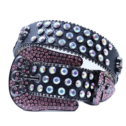 Unisex black textured leather belt, featuring skull studs and iridescent white rhinestones, highlighted with pink crystal accents for a bold and stylish statement. Add a touch of luxury and sparkle to your outfit with the Unisex Black Leather Belt from Real Rhinestone. Featuring a black leather strap, this stylish belt is adorned with iridescent and pink Color diamond rhinestones, creating a bold and glamorous look. The Gray buckle, decorated with iridescent and pink crystal rhinestones, enhances the design with extra shine and sophistication. Designed for versatility and comfort, this belt is perfect for both casual and dressy occasions. Whether you are looking to complete a hip-hop-inspired outfit, make a statement at an event, or simply add some extra bling to your wardrobe, this belt is the perfect accessory. Its adjustable fit ensures all-day comfort, while the high-quality materials guarantee durability and long-lasting wear. Elevate your style effortlessly with the Unisex Black Leather Belt. Whether you are hitting the stage, going out with friends, or just upgrading your everyday look, this belt is a must-have. Order now from Real Rhinestone and bring some diamond-studded brilliance to your collection. Material: Premium Leather Rhinestone: Luxury Hand-Set High-Gloss Crystal Diamond Embellishments Buckle Type: Classic horseshoe Zinc Buckle Set Featuring Engraved Design & Sparkling Rhinestones Width: 4cm (1.5 Inch) Style: Streetwear, Cowboy, Western, Partywear, Festivals & Performances, Fashion, Hip Hop, Bling, Diamond Belt Measurement: Please note that measurements may vary by 1-2 cm. Our belts are measured from the fold where the buckle is attached to the middle hole. For the best fit, we recommend measuring a belt you already own from the fold to the hole you use most frequently. Ideally, the belt should be worn on the third hole for optimal fit and comfort.