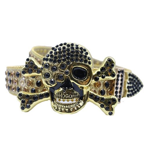 Gold glitter leather belt, accented with black and gold rhinestones along the strap and a dramatic buckle featuring a gold-tone skull and crossbones encrusted with rhinestones Add a touch of luxury and sparkle to your outfit with the Unisex Gold Leather Belt from Real Rhinestone. Featuring a sleek Gold leather strap, this stylish belt is adorned with  Black and Gold Color diamond rhinestones, creating a bold and glamorous look. The Silver buckle, decorated with black crystal rhinestones, enhances the design with extra shine and sophistication. Designed for versatility and comfort, this belt is perfect for both casual and dressy occasions. Whether you are looking to complete a hip-hop-inspired outfit, make a statement at an event, or simply add some extra bling to your wardrobe, this belt is the perfect accessory. Its adjustable fit ensures all-day comfort, while the high-quality materials guarantee durability and long-lasting wear. Elevate your style effortlessly with the Unisex Gold Leather Belt. Whether you are hitting the stage, going out with friends, or just upgrading your everyday look, this belt is a must-have. Order now from Real Rhinestone and bring some diamond-studded brilliance to your collection. Material: Premium Leather Rhinestone: Luxury Hand-Set High-Gloss Crystal Diamond Embellishments Buckle Type: Classic Skull Zinc Buckle Set Featuring Engraved Design & Sparkling Rhinestones Width: 4cm (1.5 Inch) Style: Streetwear, Cowboy, Western, Partywear, Festivals & Performances, Fashion, Hip Hop, Bling, Diamond Belt Measurement: Please note that measurements may vary by 1-2 cm. Our belts are measured from the fold where the buckle is attached to the middle hole. For the best fit, we recommend measuring a belt you already own from the fold to the hole you use most frequently. Ideally, the belt should be worn on the third hole for optimal fit and comfort.
