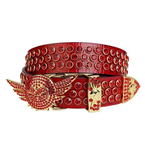 Unisex Red Textured Leather Belt Highlighted With Red Rhinestones And Polished Gold wing Buckle Add a touch of luxury and sparkle to your outfit with the Unisex Red Leather Belt from Real Rhinestone. Featuring a sleek Red leather strap, this stylish belt is adorned with Red Color diamond rhinestones, creating a bold and glamorous look. The Gold buckle, decorated with red rhinestones, enhances the design with extra shine and sophistication. Designed for versatility and comfort, this belt is perfect for both casual and dressy occasions. Whether you are looking to complete a hip-hop-inspired outfit, make a statement at an event, or simply add some extra bling to your wardrobe, this belt is the perfect accessory. Its adjustable fit ensures all-day comfort, while the high-quality materials guarantee durability and long-lasting wear. Elevate your style effortlessly with the Unisex Red Leather Belt. Whether you are hitting the stage, going out with friends, or just upgrading your everyday look, this belt is a must-have. Order now from Real Rhinestone and bring some diamond-studded brilliance to your collection. Material: Premium Leather Rhinestone: Luxury Hand-Set High-Gloss Crystal Diamond Embellishments Buckle Type: Classic wing Zinc Buckle Set Featuring Engraved Design & Sparkling Rhinestones Width: 4cm (1.5 Inch) Style: Streetwear, Cowboy, Western, Partywear, Festivals & Performances, Fashion, Hip Hop, Bling, Diamond Belt Measurement: Please note that measurements may vary by 1-2 cm. Our belts are measured from the fold where the buckle is attached to the middle hole. For the best fit, we recommend measuring a belt you already own from the fold to the hole you use most frequently. Ideally, the belt should be worn on the third hole for optimal fit and comfort.