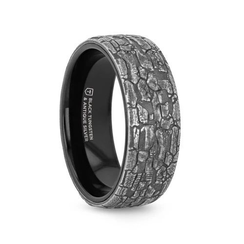Black Tungsten Ring with Grey Stonework Pattern This black tungsten ring showcases a stunning grey stonework pattern along the outside, blending rugged texture with a refined, modern aesthetic. The combination of tungsten's strength and the intricate design offers both durability and visual impact, making it a unique statement piece for any occasion. Key Features: Black Tungsten Construction: Known for its extreme durability and resistance to scratches, ensuring the ring retains its flawless appearance over time. Grey Stonework Pattern: A distinctive, textured grey pattern on the outer surface that evokes the appearance of stone, adding depth and character to the design. Bold and Rugged Aesthetic: The stonework pattern contrasts beautifully with the sleek black tungsten, creating an edgy yet sophisticated look. Comfort Fit Design: Crafted for ease and comfort, providing a smooth fit for daily wear. Hypoallergenic: Safe for all skin types, as tungsten is a hypoallergenic metal that won’t irritate sensitive skin. Timeless and Versatile: Perfect for both formal and casual settings, offering a modern twist on classic design with an eye-catching texture. Metal Type: Black Tungsten Color: Gray Finish: Matte SKU: B1224-BTMS