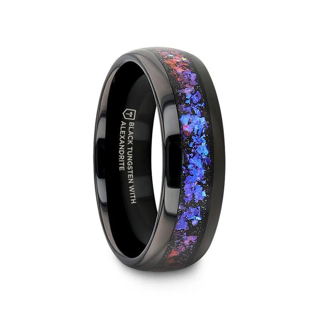 Channel your inner fashion icon with our COSMIC Black Tungsten Ring, featuring dazzling Synthetic Crushed Alexandrite and shimmering Dark Blue and Purple Crushed Goldstone. Domed-style jewelry is created using a variety of methods to achieve a rounded or convex shape. Popular for its stylish, versatile, and comfortable design. Black tungsten jewelry offers a striking and contemporary aesthetic. The black finish is achieved through a PVD (Physical Vapor Deposition) process, which provides a sleek, dark appearance while maintaining the inherent durability and scratch resistance of tungsten. Polished finish enhances the overall aesthetic of the piece, giving it a lustrous and elegant finish, making it a popular choice for those who appreciate a sleek and refined look. Brand: Thorsten Metal Type: Black Tungsten Color: Black|Blue Finish: Polished Style: Domed Stones: None SKU: C0723-BPBC