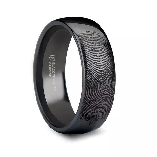 Fingerprint Engraved Domed Black Tungsten Ring Polished - 4mm - 12mm Customize this precision crafted ring from our line of Comfort Fit Black Tungsten Carbide Rings with a fingerprint of you, or your loved one. Fingerprints can be engraved on the inside or outside of this band, all fingerprints are engraved on the outside of the band unless specifically stated in your order notes. Covered by Thorsten's lifetime warranty and sizing exchange. Available in 4mm, 6mm, 7mm, 8mm, 10mm, and 12mm. Brand: Thorsten Metal Type: Black Tungsten Color: Black Finish: Polished Style: Domed|Engraved Stones: None SKU: F869-DPBT