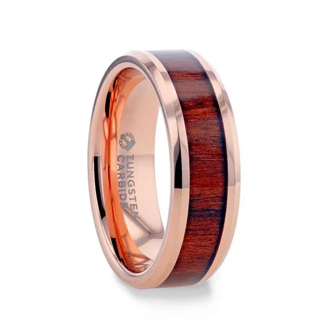 DYLAN Rose Gold Plated Koa Wood Inlaid Tungsten Men's Wedding Band With Beveled Polished Edges - 8mm A thorn between two roses. The DYLAN is a rose gold Tungsten band with a beautiful Koa wood inlay. The top has a shiny, flat, and even finish that ties the whole thing together, which gives way to soft, beveled edges. The edges are also polished, smooth to the touch. It comes in an 8mm width and several sizes. This ring can be custom engraved! Adding a flair will not delay orders. You don’t ever have to worry again with Thorsten’s Standard Lifetime and Lifetime Sizing warranties (excludes re-engraving). Available in 8mm width. Gorgeous rose gold Tungsten band with Koa wood inlay and beveled edges. Made of 85% Tungsten and 15% Nickel, the metal alloy is hypoallergenic. Tungsten is easy to clean with some soap and warm water! After, polish it with a soft cloth. Brand: Thorsten Metal Type: Tungsten Carbide Color: Brown|Rose Gold Finish: Polished Style: Wood Inlay Stones: None SKU: TURG-0006
