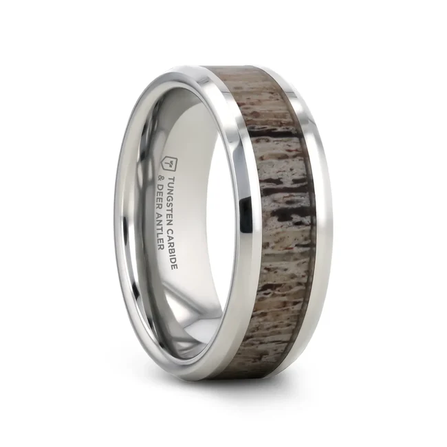 This unique and exquisite, polished and beveled Tungsten Carbide ring by Thorsten features a skillfully-crafted and gracefully set inlay of light brown deer antler with subtle hues of white, brown, and navy. Perfect for the outdoor enthusiast or hunter! Engraving available! See Pictures for Details. Does Not Delay Order Includes Thorsten Lifetime and Lifetime Sizing Warranty (excluding re-engraving). Other widths available upon request as a custom order. Each antler ring pattern is unique and will differ in each ring. Tungsten Carbide—the newest and strongest metal for jewelry that does not scratch easily. Comfort Fit – domed interior band slides over the knuckle easier with less friction Brand: Thorsten Metal Type: Tungsten Carbide Color: Silver|White Finish: Polished Style: Beveled Stones: None SKU: W1536-TCBD