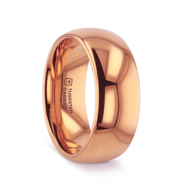 The classic domed style Tungsten Carbide wedding band by Thorsten is finally available with a rich rose gold-plated finish giving it a beautiful gold copper hue. Can be worn as a wedding band or promise ring.  Engraving available! See Pictures for Details. Does Not Delay Order. Includes Thorsten Lifetime and Lifetime Sizing Warranty (excluding re-engraving). Available in 4mm, 6 mm, and 8mm widths for couples who want a matching set. Tungsten Carbide is the newest and strongest metal for jewelry that does not scratch easily. Please note, Gold Tungsten Carbide rings are much more durable than 14k gold rings but can be scratched. Comfort Fit – domed interior band slides over the knuckle easier with less friction. Brand: Thorsten Metal Type: Tungsten Carbide Color: Rose Gold Finish: Polished Style: Domed Stones: None SKU: W1968-DPGT