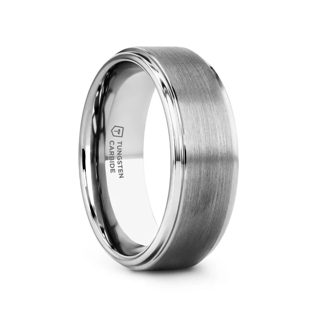 An all-time favorite, this classic Tungsten Carbide Ring design by Thorsten has a smooth raised brush finished center with highly-polished and rounded step-down edges. A perfect blend of strength and beauty.  Includes Thorsten Lifetime and Lifetime Sizing Warranty (excluding re-engraving) Tungsten Carbide—the newest and strongest metal for jewelry that does not scratch easily. Comfort Fit – domed interior band slides over the knuckle easier with less friction Brand: Thorsten Metal Type: Tungsten Carbide Color: Silver Finish: Brushed Style: Flat|Raised Center Stones: None SKU: W241-RSC