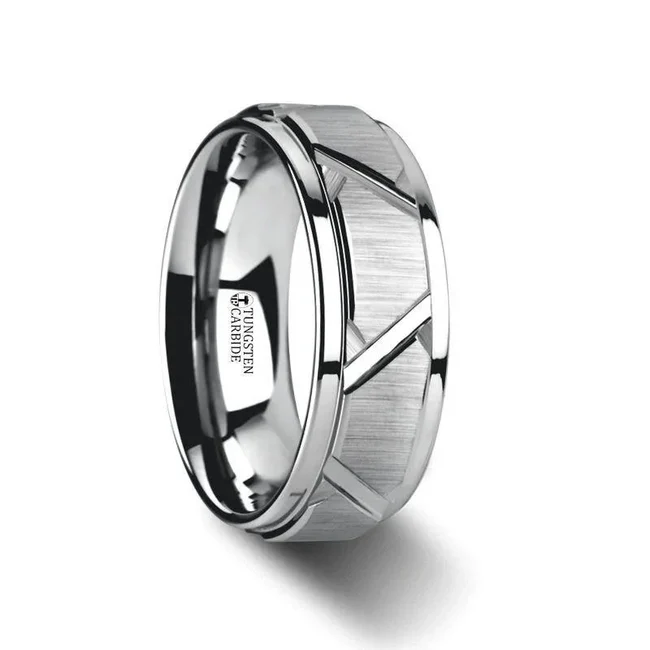 Unique, masculine, bold and eye-catching aptly describe this beautiful Tungsten Carbide ring by Thorsten with its intricate raised and brushed angular cuts. Engraving available! See Pictures for Details. Does Not Delay Order. Includes Thorsten Lifetime and Lifetime Sizing Warranty (excluding re-engraving). Available in 8mm width. Tungsten Carbide is the newest and strongest metal for jewelry that does not scratch easily. Comfort Fit – domed interior band slides over the knuckle easier with less friction. Brand: Thorsten Metal Type: Tungsten Carbide Color: Silver Finish: Brushed Style: Flat|Grooved Stones: None SKU: W3073-TCRC
