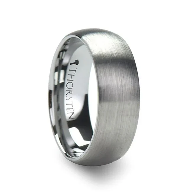This simple yet elegant design is perfect for couples who prefer a clean and refined look to their wedding rings. These classic domedstyle Tungsten Carbide Rings by Thorsten feature a fine brush finish and rounded edges. Engraving available! See Pictures for Details. Does Not Delay Order Available in 2mm, 4mm, 6mm,7mm, 8mm, 10mm, and 12mm widths for couples who want a matching set Tungsten Carbide — the newest and strongest metal for jewelry that does not scratch easily. Comfort Fit – domed interior band slides over the knuckle easier with less friction Brand: Thorsten Metal Type: Tungsten Carbide Color: Silver Finish: BrushedStyle: Domed Stones: None SKU: W339-DBT