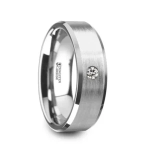 PORTER Brushed Finish Tungsten Carbide Wedding Ring with White Diamond Setting and Beveled Edges- 8 mm This extremely desired tungsten carbide wedding ring is one of the most sought after designs in men's wedding bands. Created with a detailed brushed finish and high polish beveled edges, the single white diamond shows beautifully against the brushed finish. This tungsten carbide wedding band is available in 6mm and 8mm widths. A 0.06 carat classic round cut white diamond is set into this beautiful tungsten ring and has a color I and clarity of I1. This is the perfect wedding band to represent your love and commitment. Note, inlay is protected by a resin that can be scratched. Re-sizing and Warranty on all Thorsten alternative metal rings, no exchange|sizing fees. Brand: Thorsten Metal Type: Tungsten Carbide Color: Gray|Silver|White Finish: Brushed Style: Beveled|Diamonds Stones: Natural Diamond SKU: W4286-TCWD