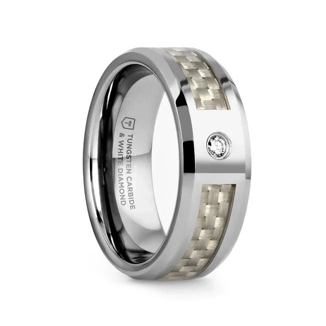 ROYCE Tungsten Carbide Wedding Band with White Carbon Fiber and White Diamond - 8mm Modern and luxurious this Tungsten Carbide wedding band design by Thorsten has a flat profile with polished beveled edges and is made by cutting a channel for the pure white Carbon Fiber inlay almost all the way around the ring, leaving only a setting area for a magnificent 0.06 carat White Diamond. Engraving available! See Pictures for Details. Does Not Delay Order. Includes Thorsten Lifetime and Lifetime Sizing Warranty (excluding re-engraving). Available in an 8mm width. Tungsten Carbide is the newest and strongest metal for jewelry that does not scratch easily. Comfort Fit – domed interior band slides over the knuckle easier with less friction. Brand: Thorsten Metal Type: Tungsten Carbide Color: Silver|White Finish: Polished Style: Beveled|Carbon Fiber Inlay|Diamonds Stones: Natural Diamond SKU: W803-WCWD